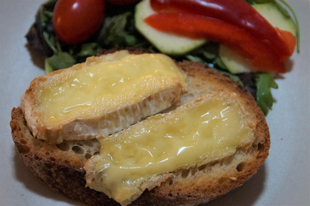 Oven baked Camembert cheese on bread