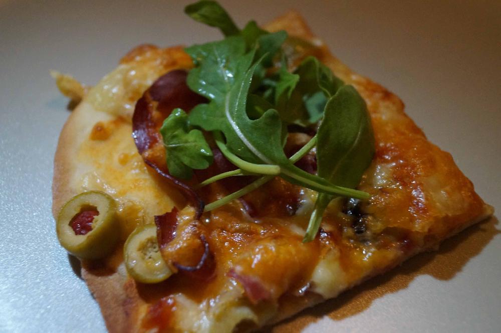 Pizza with serrano ham and olives