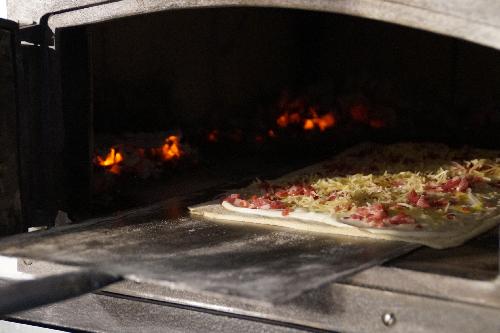 Traditional tarte flambée in wood-fire oven picture